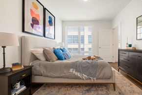 Philadelphia apartment for rent - a bedroom with a bed and a dresser and a window