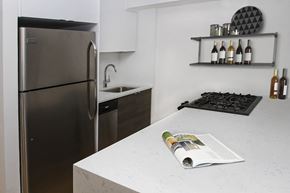 New York apartment for rent - a kitchen with a counter top and a refrigerator