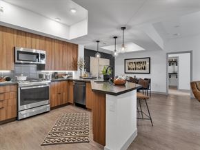 Las Vegas apartment for rent - A modern kitchen with wooden cabinets and stainless steel appliances.