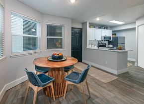 Westminster apartment for rent - A kitchen with a table and chairs in the foreground and a refrigerator in the background.