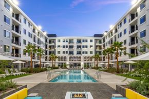 Las Vegas apartment for rent - A large white building with a pool in the middle of it.
