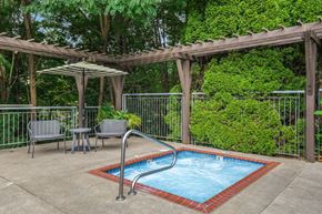 Lake Oswego apartment for rent - A small pool surrounded by a fence and a pergola.