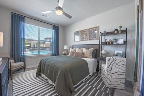 Denton apartment for rent - A bedroom with a large bed and a ceiling fan.