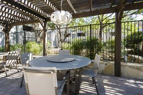 San Antonio apartment for rent - a patio with a table and chairs under a pergola
