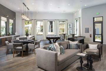 Moreno Valley apartment for rent - A living room with a grey couch and a black table.