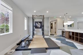Englewood apartment for rent - A gym with a row of treadmills and a pull up bar.