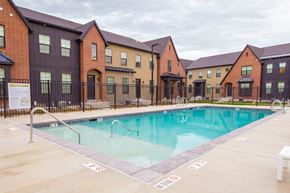 Lehi townhouse for rent - a swimming pool with apartments in the background