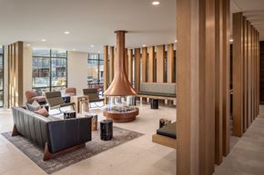 Oklahoma City apartment for rent - A modern living room with a fireplace and a long wooden column.