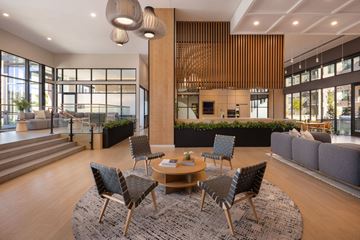 Aurora apartment for rent - A modern living room with a wooden table and chairs.