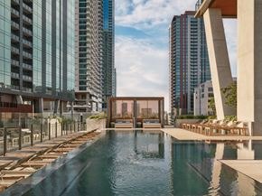 Austin apartment for rent - A pool in the middle of a city surrounded by buildings.