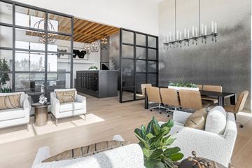 Montclair apartment for rent - A modern living room with a white sofa set and a black cabinet.