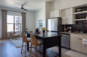 Vineyard apartment for rent - A kitchen with a table and chairs in front of a window.