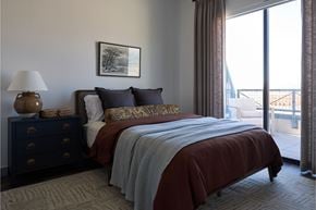 Vineyard apartment for rent - A bedroom with a large bed and a view of the outside.