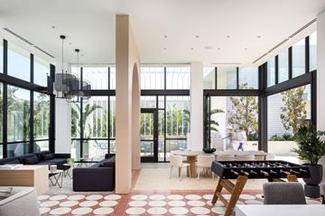 Burbank apartment for rent - A modern living room with a foosball table in the middle.