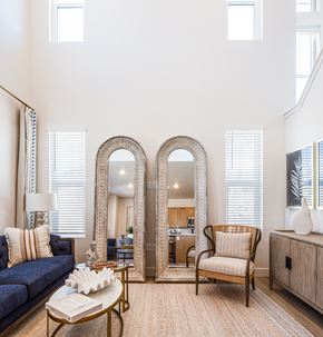 Murray townhouse for rent - A living room with a sofa, a chair, a coffee table, and two mirrors.
