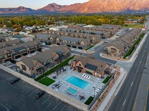 Murray townhouse for rent - A large residential complex with a swimming pool and a mountain in the background.