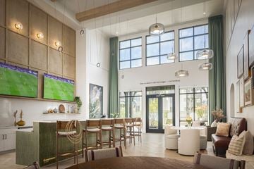 Grand Prairie apartment for rent - A modern living room with a television and a bar area.