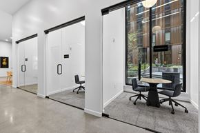 Portland apartment for rent - A conference room with a table and chairs is visible through glass doors.
