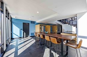 Las Vegas apartment for rent - A modern dining room with a long table and chairs.