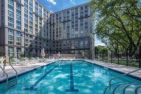 New York apartment for rent - a swimming pool in front of a tall building