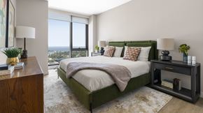 New Rochelle apartment for rent - A bedroom with a large bed and a view of the city.