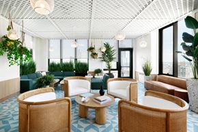 New Rochelle apartment for rent - A modern living room with a white ceiling and a mix of wicker and leather furniture.
