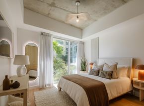 San Marcos apartment for rent - A bedroom with a large bed and a window with curtains.