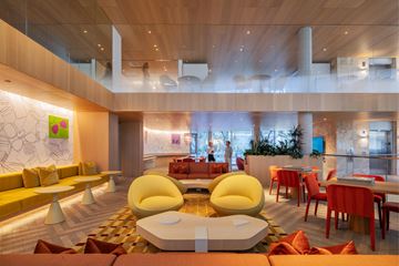 San Marcos apartment for rent - A modern living room with a yellow sofa and a glass table.