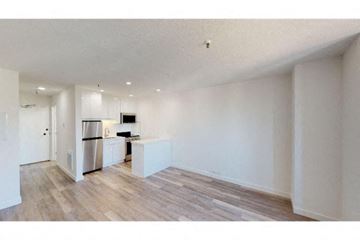 San Francisco apartment for rent - A kitchen with white cabinets and a refrigerator is visible.