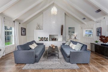 Orlando apartment for rent - A living room with grey couches and a white fireplace.