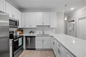 Charleston apartment for rent - A modern kitchen with white cabinets and stainless steel appliances.