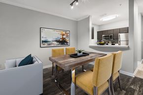 Orlando apartment for rent - A dining room with a wooden table and yellow chairs.