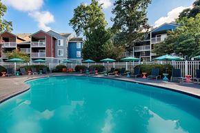 Wilsonville apartment for rent - Large outdoor pool with lounge chairs and colorful tables at Canyon Creek Apartments, Wilsonville, 97070