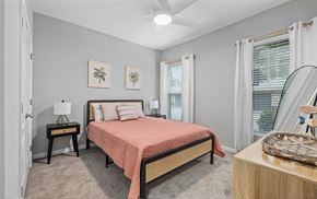 Charleston apartment for rent - A bedroom with a bed, nightstand, and a painting on the wall.