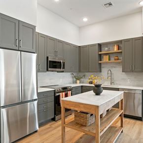 Littleton apartment for rent - A kitchen with a table and a refrigerator.