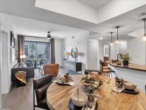 Las Vegas apartment for rent - A modern dining room with a wooden table set for a meal.