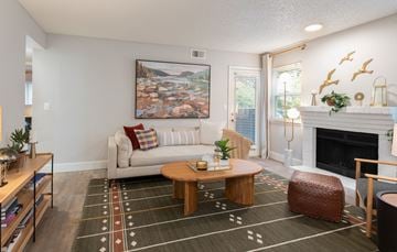 Westminster apartment for rent - A living room with a white couch, a coffee table, and a painting on the wall.