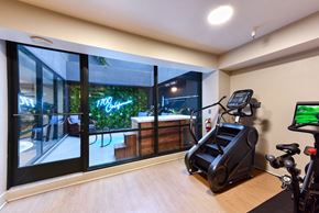 San Francisco apartment for rent - A home gym with a treadmill, exercise bike, and a view of the outdoors. at 1700 California Street, San Francisco