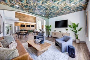Las Vegas apartment for rent - A living room with a wooden coffee table and a grey armchair.
