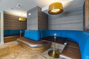Flower Mound apartment for rent - A modern dining area with a wooden table and blue booths.