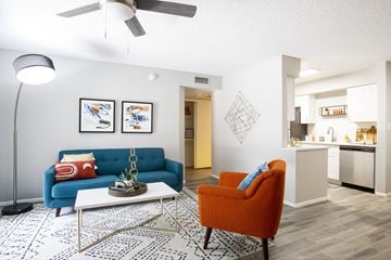 Glendale apartment for rent - A living room with a blue couch and an orange chair.