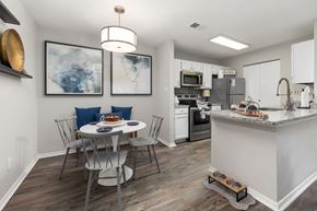 Cary apartment for rent - A kitchen with a table and chairs and a fridge.
