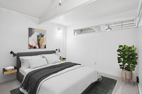Pittsburgh apartment for rent - A bedroom with a large bed and a painting on the wall.