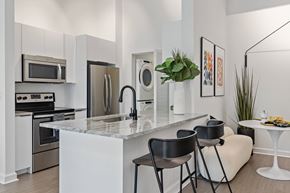 Doral apartment for rent - A modern kitchen with a marble countertop and stainless steel appliances.