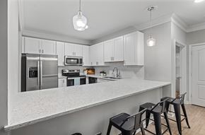 Charleston apartment for rent - A kitchen with white cabinets and a marble countertop.