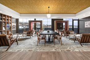 Pittsburgh apartment for rent - A modern dining room with a large table and chairs.