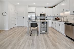 Shakopee apartment for rent - a kitchen with white cabinets and stainless steel appliances