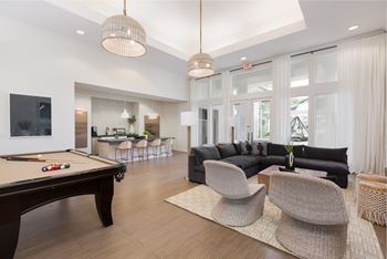 Newly renovated modern clubhouse with social seating, large flat screen tvs, coffee bar, and wi-fi lounge