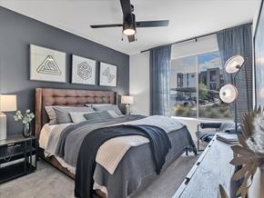 Las Vegas apartment for rent - A bedroom with a large bed and a ceiling fan.