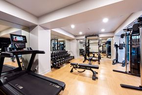 San Francisco apartment for rent - A gym with a treadmill, weights, and exercise equipment. at 1700 California Street, San Francisco, 94109